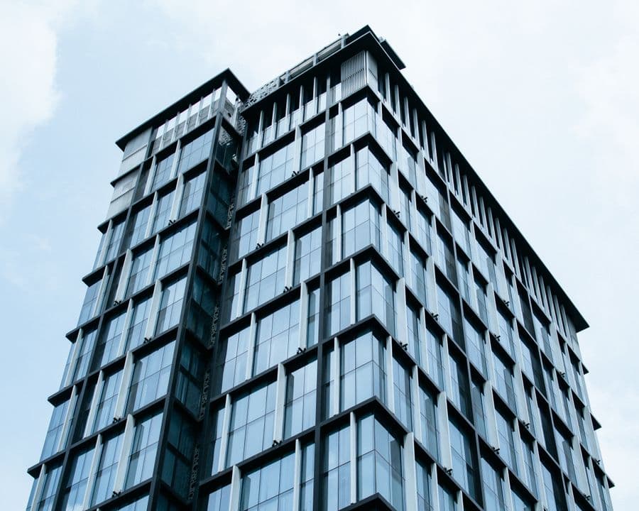 Glass office tower against a blue sky