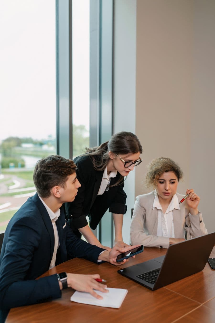 Business team reviewing work together on a laptop