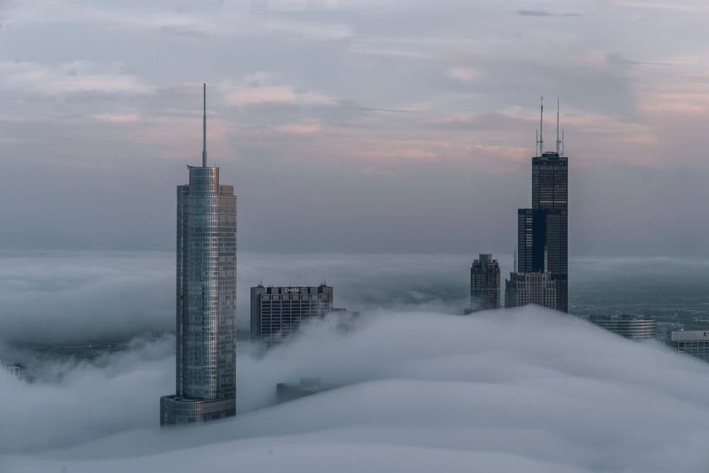 Skyscrapers rising above low clouds