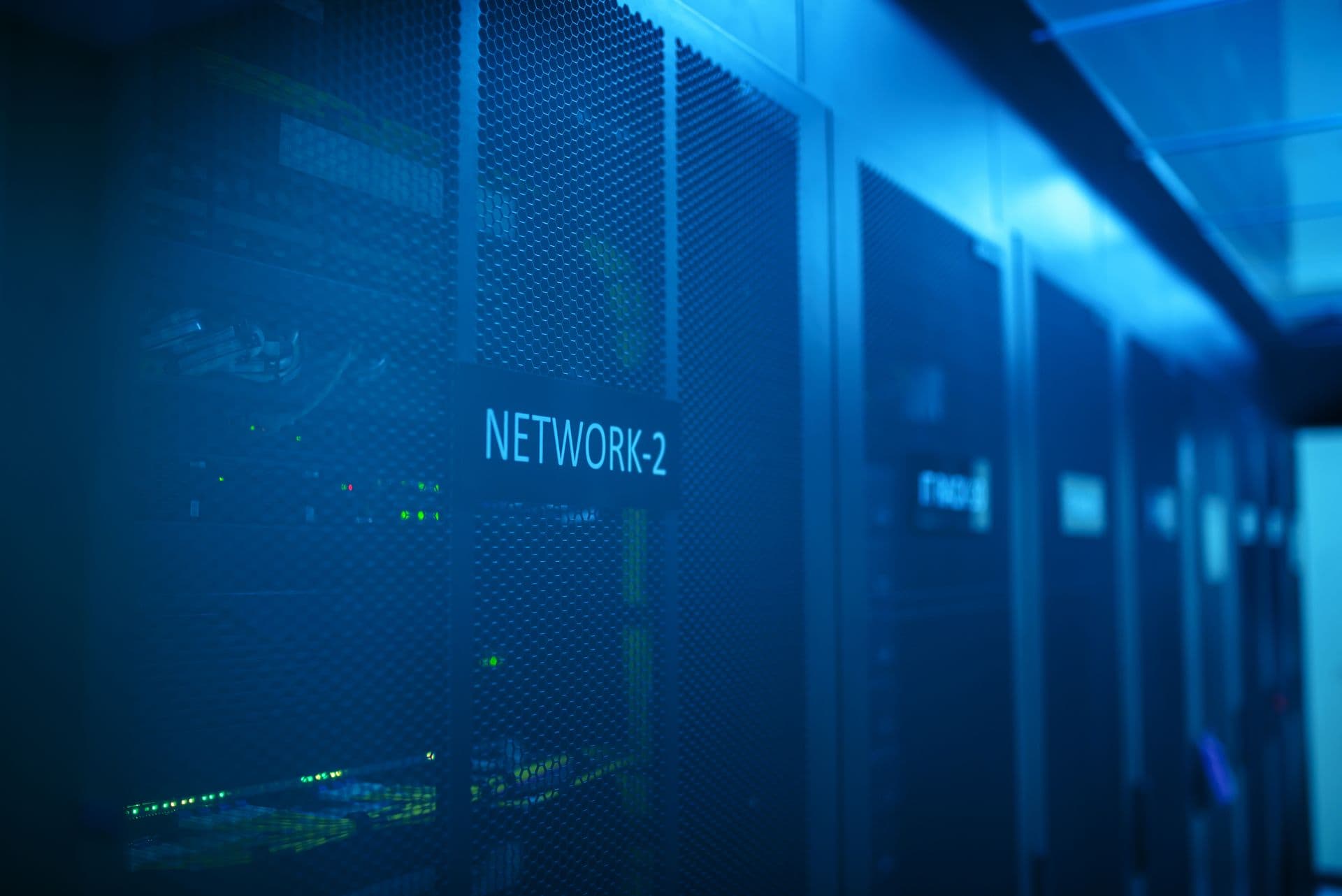 Server racks lit in blue inside a data center