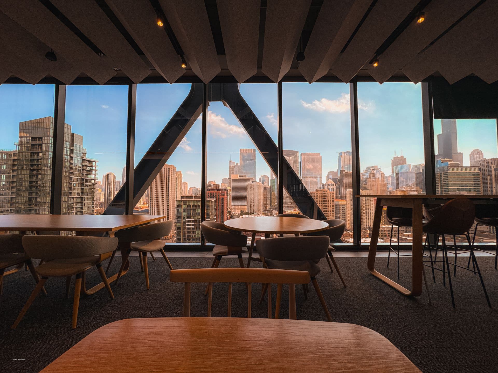 Modern office with floor-to-ceiling windows over a city skyline
