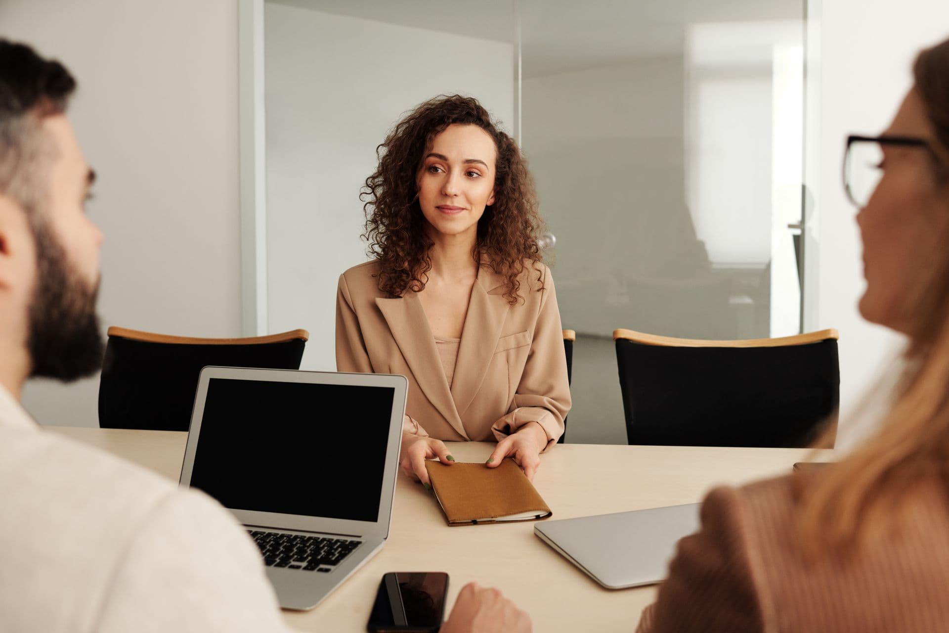 Candidate in conversation with interviewers in a bright office
